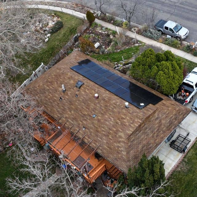 The same asphalt shingle roof with solar panels after restoration treatment.