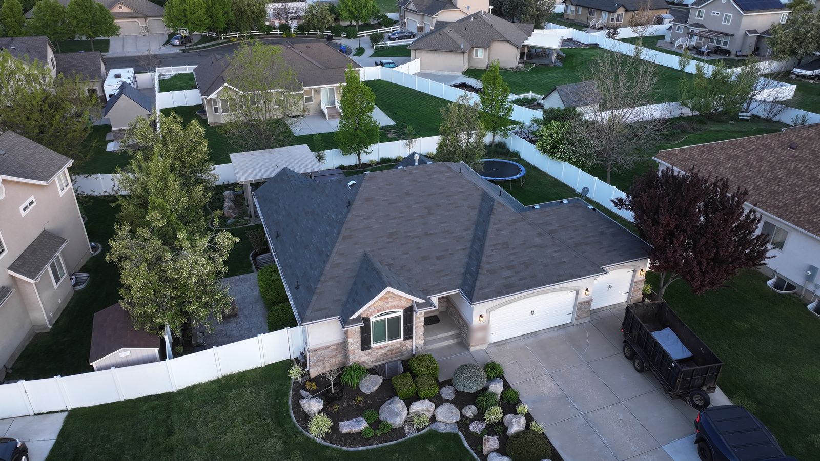 Aerial view of a Utah home's dark gray architectural asphalt shingle roof with hips and valleys