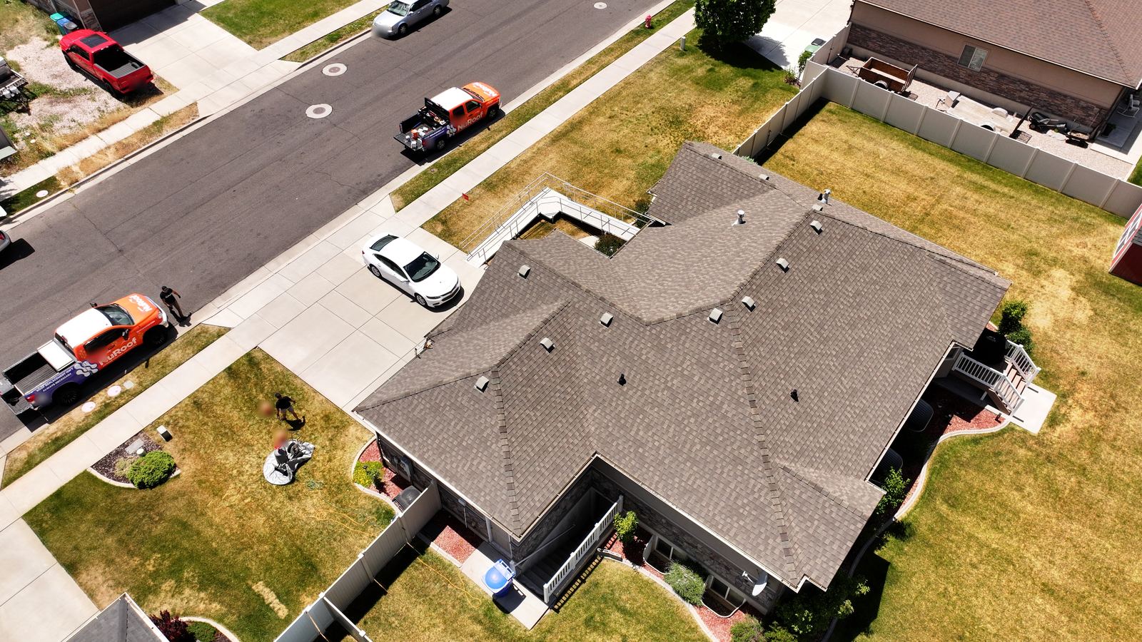 Drone view of an asphalt shingle roof with valleys and roof vents on a Utah home