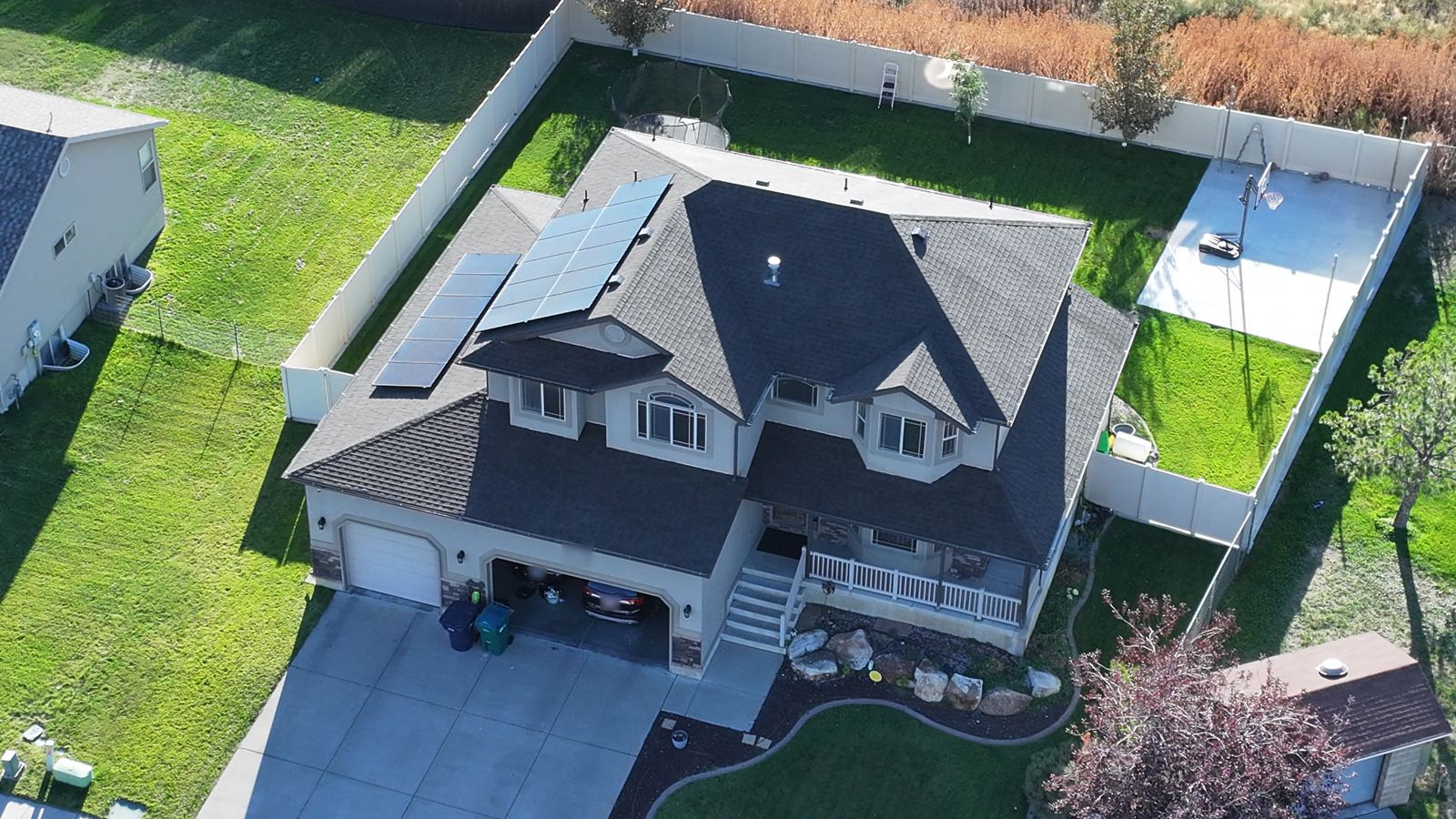 Aerial view of a two-story Utah home's shingle roof with hips, valleys and gutters