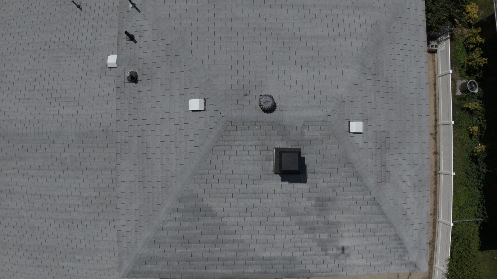 Aerial view of an aging gray Utah asphalt shingle roof, the kind of roof an inspection checks for rejuvenation candidacy