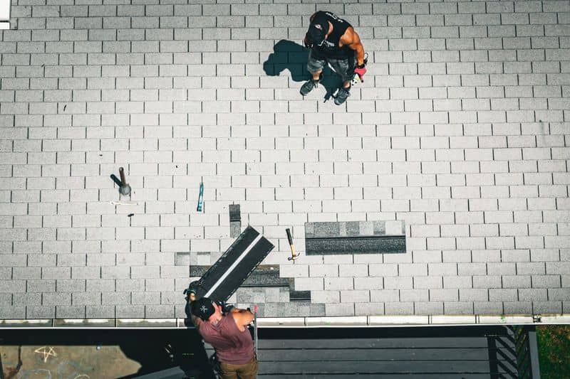 Drone view of a technician on a Northern Utah shingle roof. The NuRoof Guys.