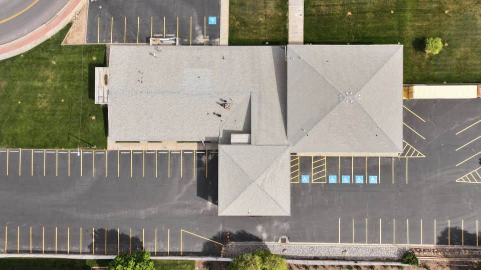 Commercial asphalt shingle roof before GoNano restoration treatment.