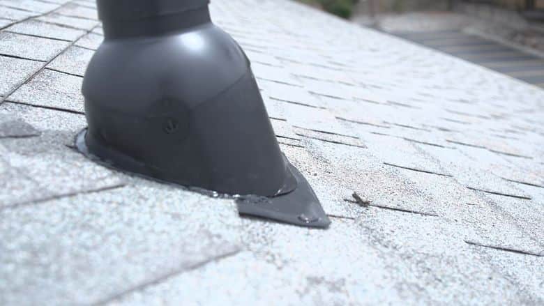 Close-up of a new pipe boot on a shingle roof. The NuRoof Guys.