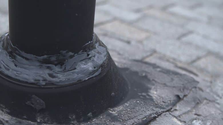 Close-up of a cracked pipe boot seal on asphalt shingles.