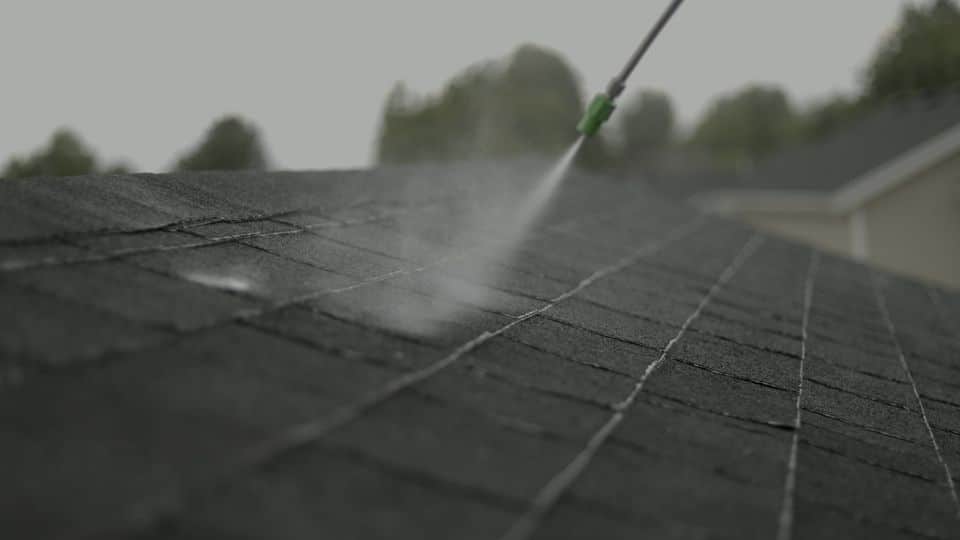 Close-up of spray mist across shingles. The NuRoof Guys.